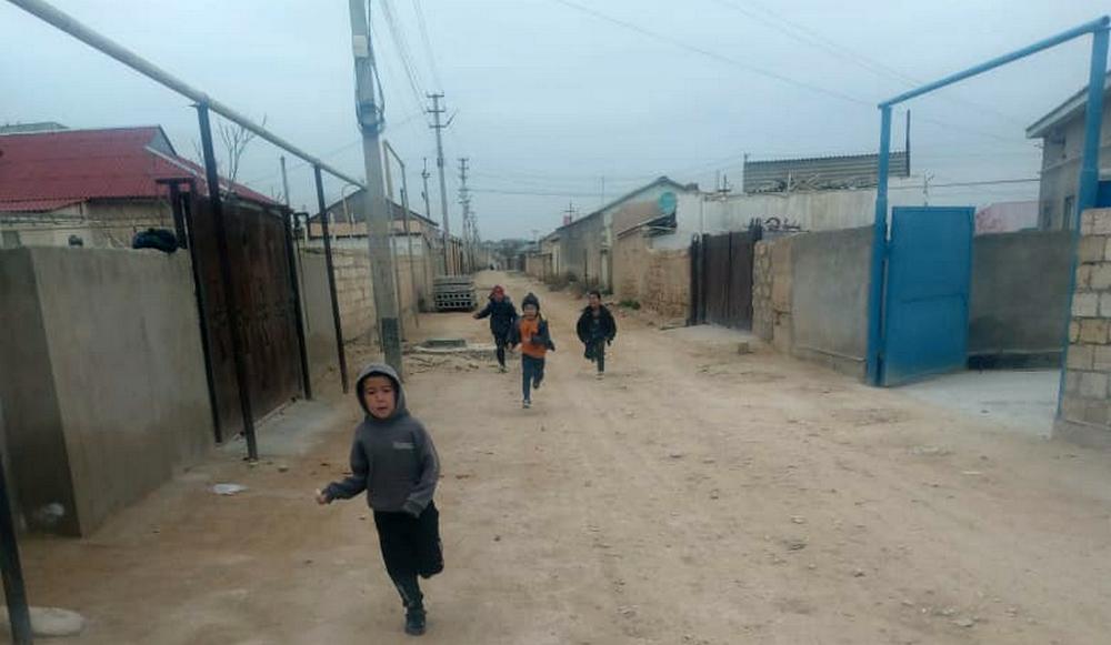 Children have to play football on the road in the suburbs of Aktau